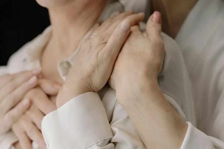 Close-up of elderly women's hands expressing love and connection, symbolizing intimacy and warmth.